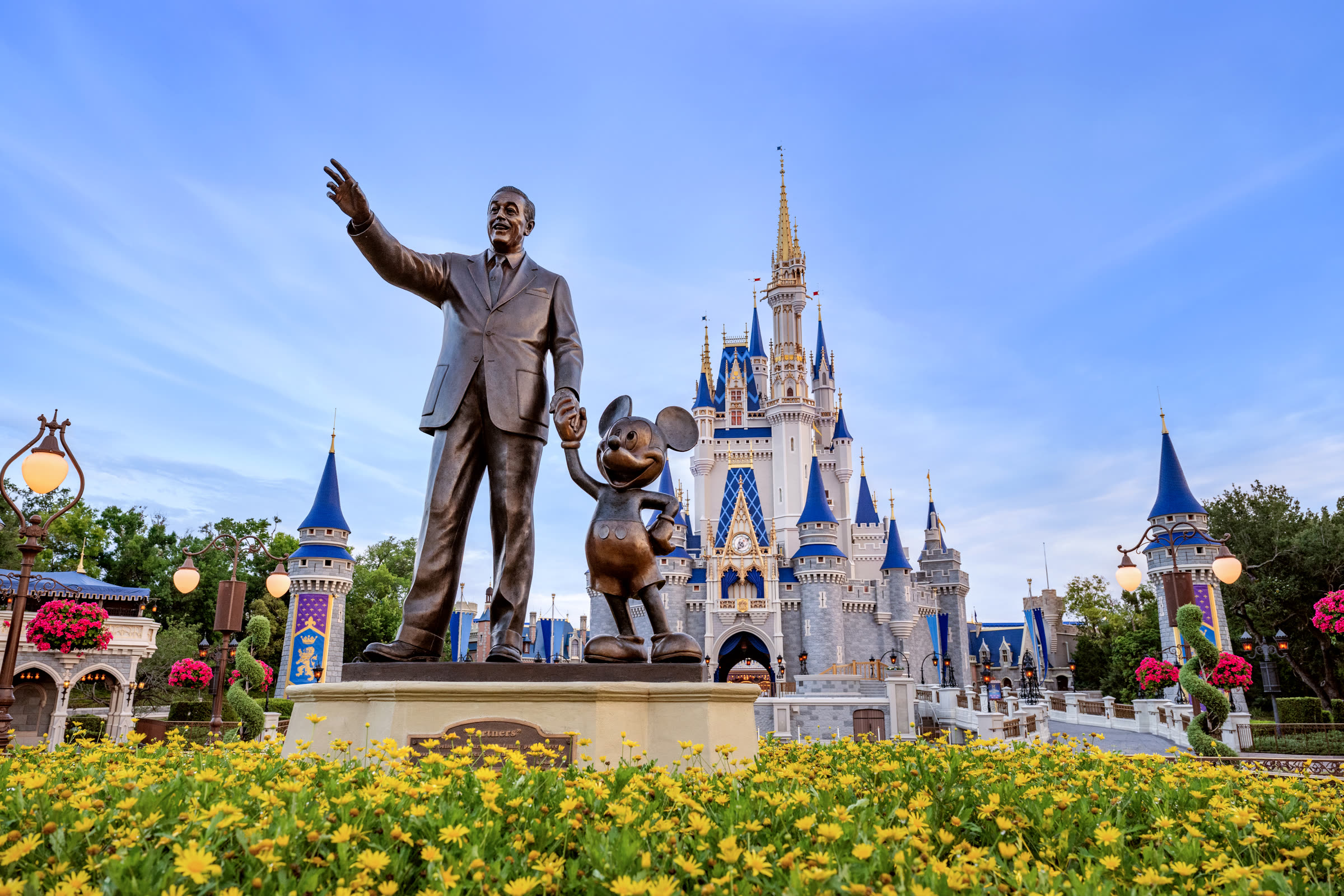 Illuminated fairy-tale castle at dusk in Magic Kingdom